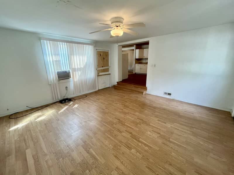 Bright bonus room with hardwood floors and large windows.
