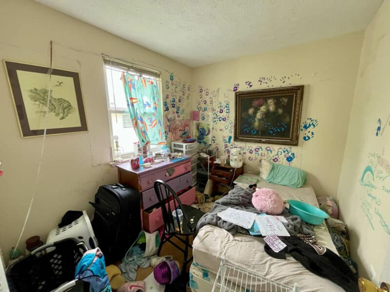 Cluttered bedroom at 2009 Halethorpe Avenue in Halethorpe Terrace, Baltimore County, with painted walls, window, and space for bed and furniture, requiring renovation.