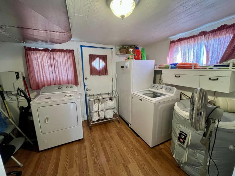 Mudroom and laundry area at 1207 Joppa Road with rear exit, utility connections, and storage space.