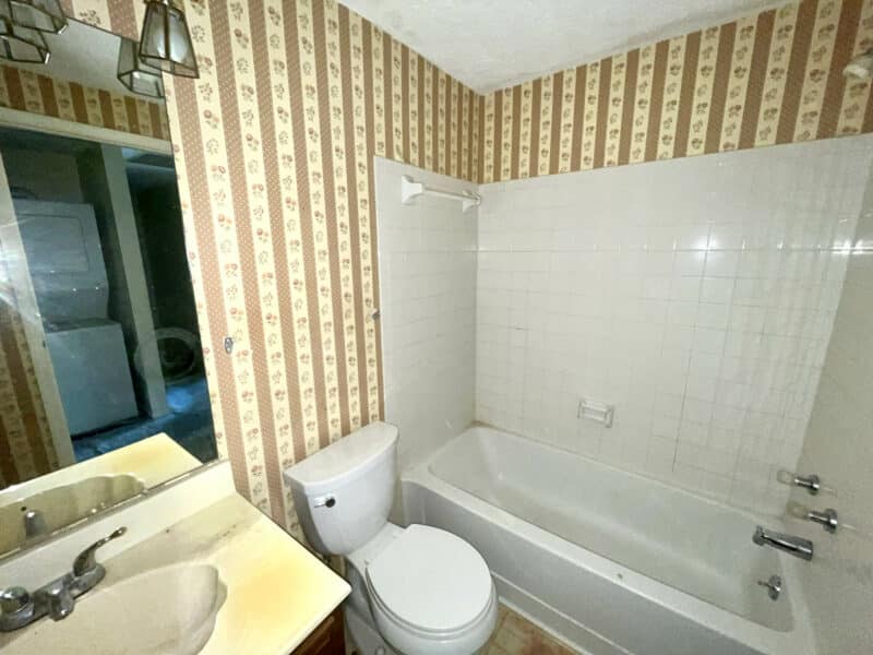Full bathroom with tub-shower combination and single vanity.