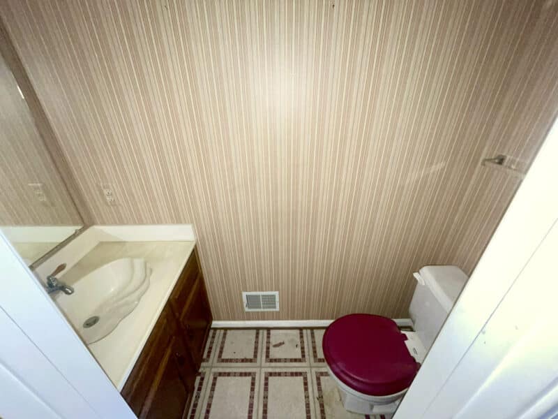 Main-level half bath with vanity and mirror.