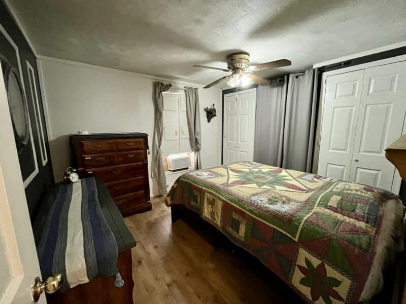 Second bedroom in farmhouse at 1207 Joppa Road in Joppa, MD, with wood-style flooring, ceiling fan, neutral walls, and large closet doors.