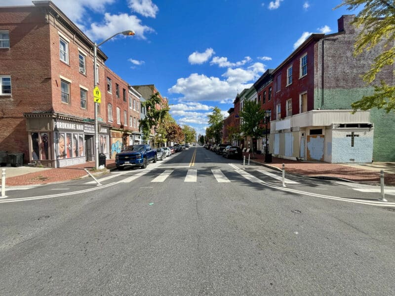 View down Baltimore Street showing mixed-use buildings and intersections.
