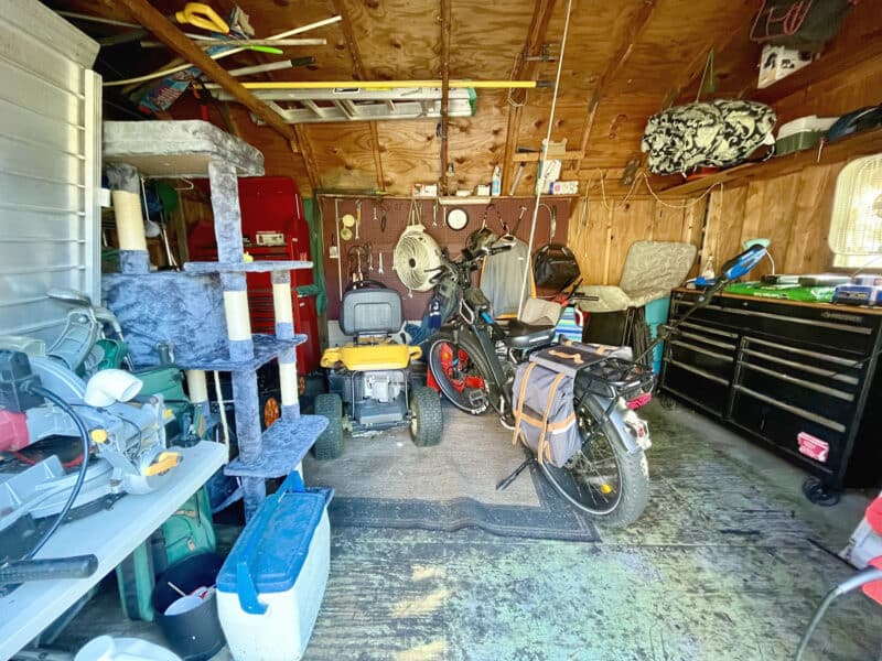 Interior of storage shed at 1207 Joppa Road showing open floor space, shelving, and personal property.
