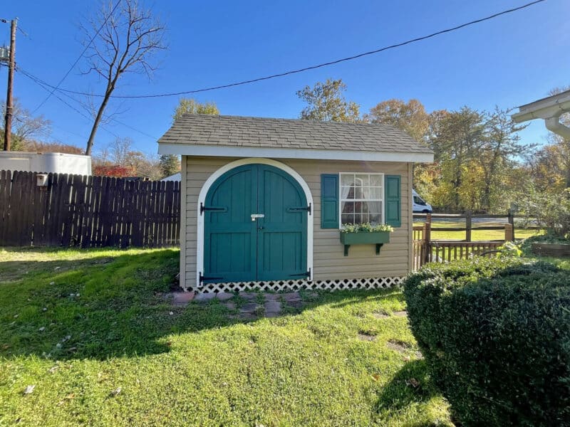 Detached workshop building at 1207 Joppa Road with wood siding and utility access.
