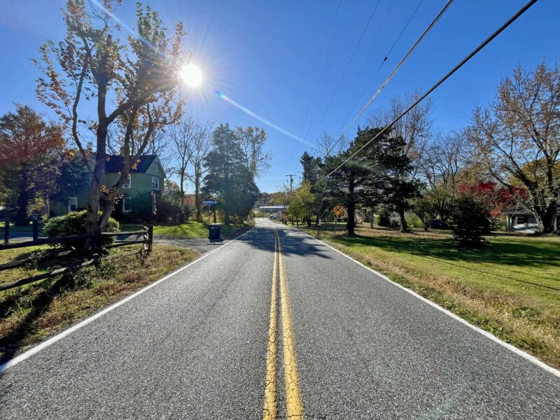 Streetscape near 1207 Joppa Road in Joppa, MD, featuring neighboring homes, driveway access, and mature greenery.