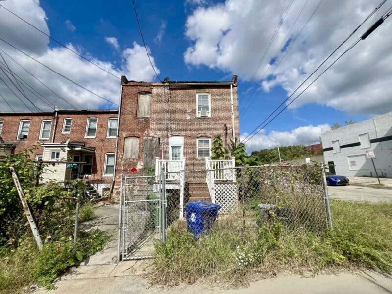 Rear view of 2701 Baker Street with fenced yard and alley access.
