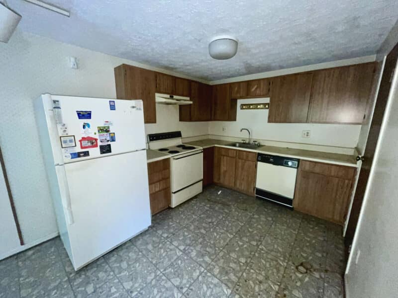 Kitchen with wood cabinets, refrigerator, stove, and dishwasher.