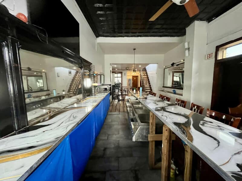 Interior rear view of the bar area showing open floor plan and seating.