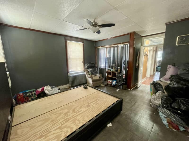 Bedroom with radiator and vinyl tile floor in Baker Street home.