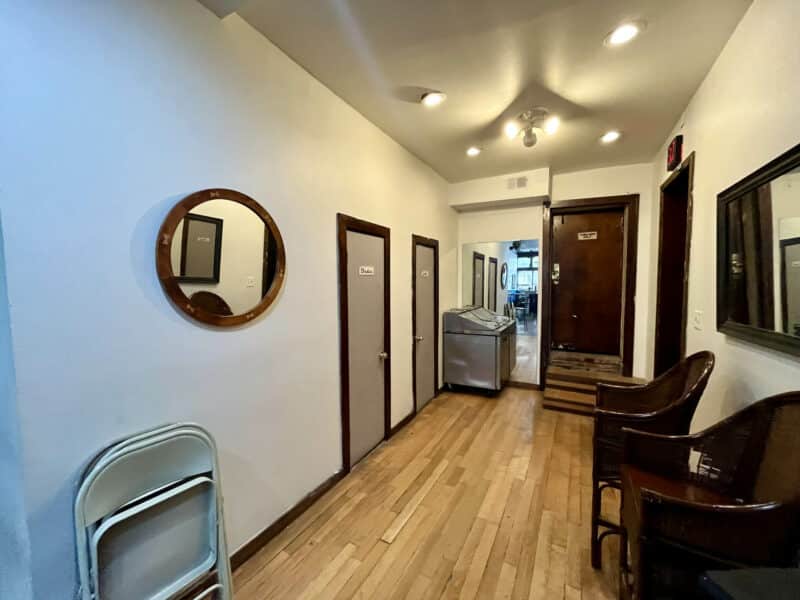 Interior hallway with hardwood floors, recessed lighting, and multiple entry doors.