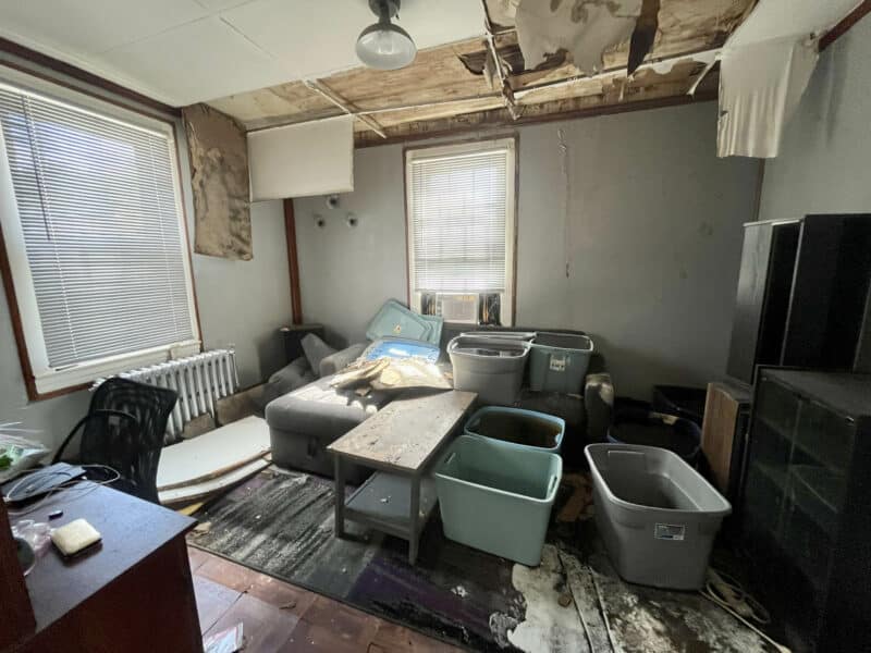 Bedroom with ceiling damage requiring renovation.
