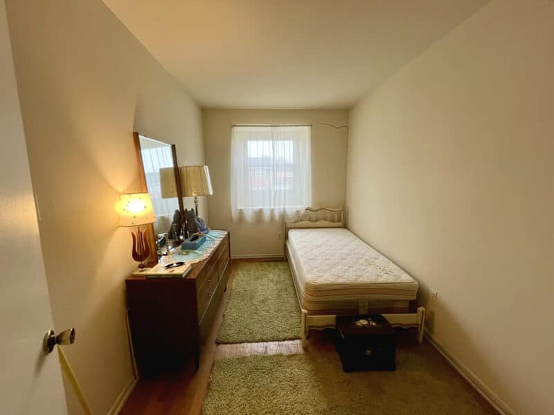 Small bedroom with a single bed, dresser, and window providing natural light at 1014 Stormont Circle.