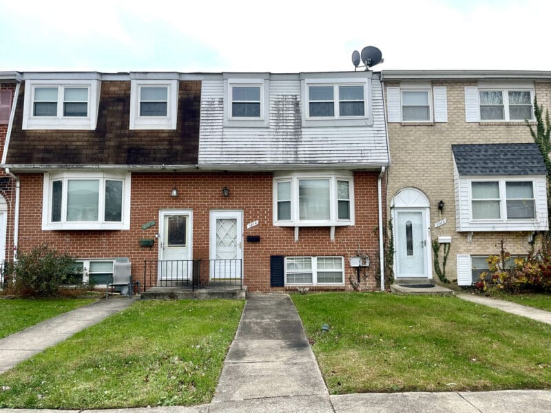 Front exterior of two-story brick townhome at 1014 Stormont Circle in Huntsmoor Village North, Arbutus.