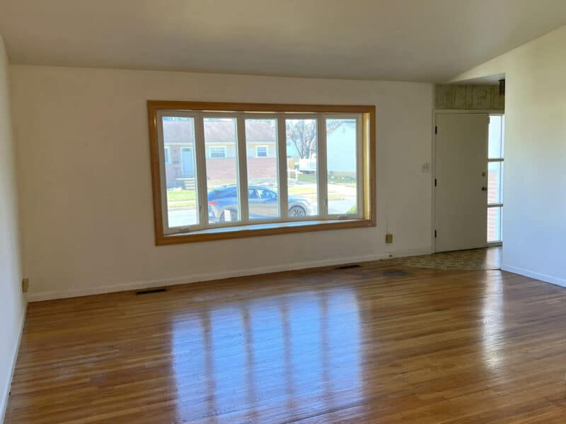 Front-facing living room view at 4729 Byron Road showing large window, hardwood floors, and open main-level layout.