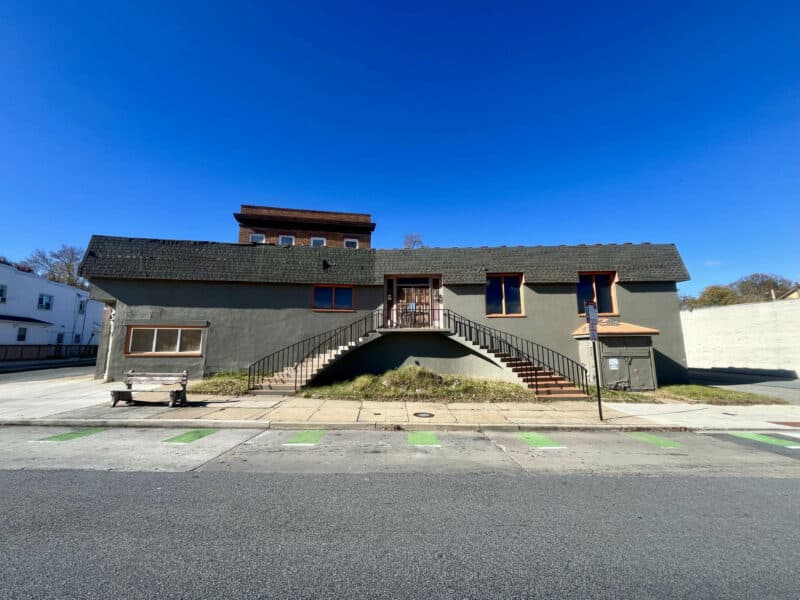 Centered front view of the commercial building at 6826–28 Harford Road showing main staircase and dual-entry elevation.