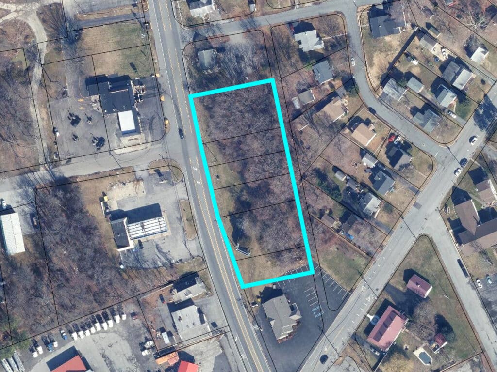 Aerial view of 1.8 acres of commercial land on N. Bridge Street in Elkton, MD, outlined in blue, showing frontage along MD-213 and surrounding commercial and residential properties.