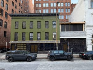 Front elevation of three-story brick commercial building at 8–14 Park Avenue in Downtown Baltimore, Maryland.