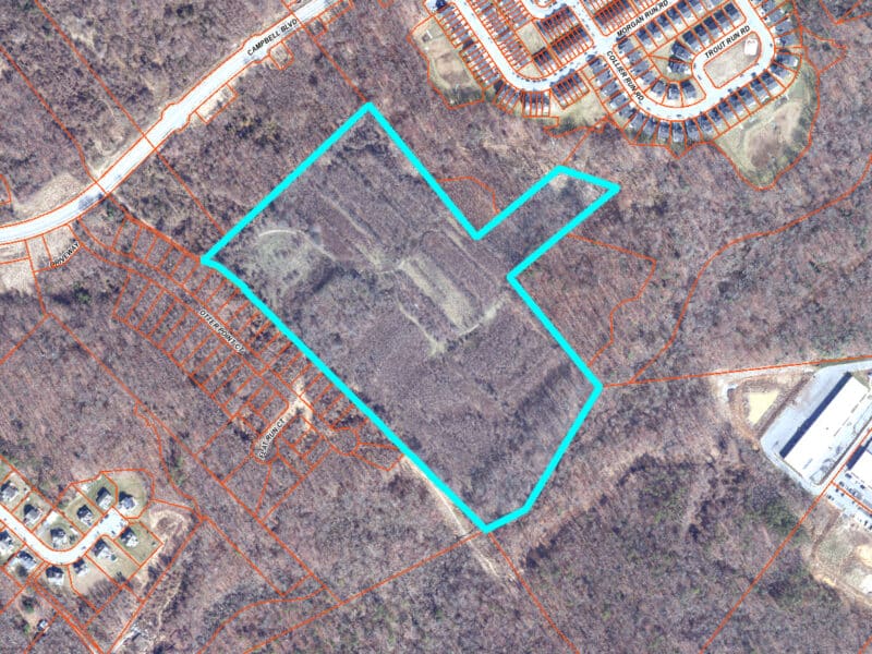 Large GIS aerial showing the 31.5± acre parcel outlined in blue, surrounded by wooded areas and adjacent residential subdivisions near Campbell Boulevard in Middle River, MD.