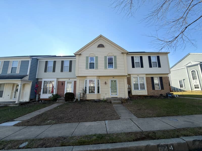 Wide front view of the townhome row including 20 Woodhollow Court in Pleasant Hills, Owings Mills, MD.