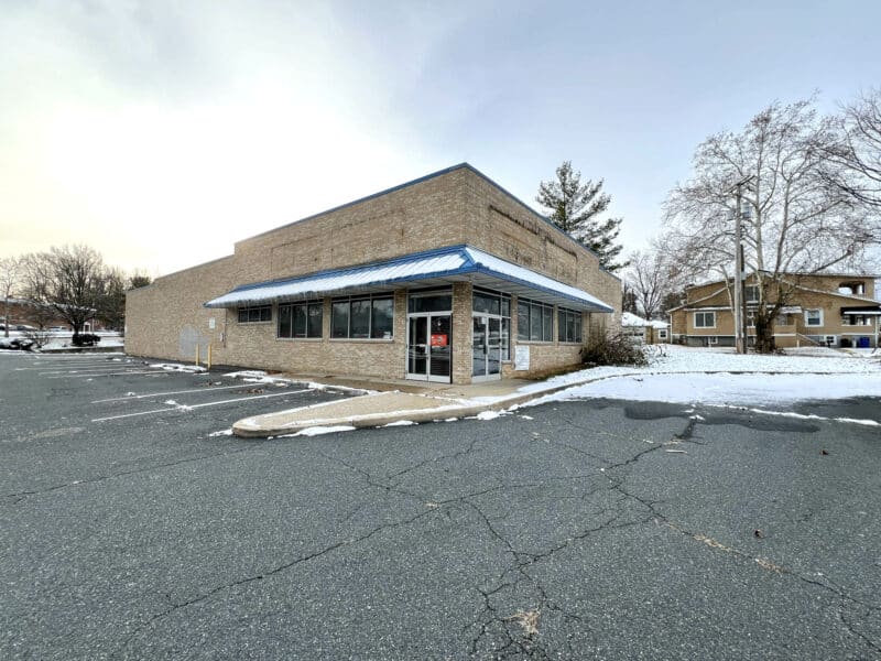 Front parking lot and exterior of retail building at 3615 E. Northern Parkway.