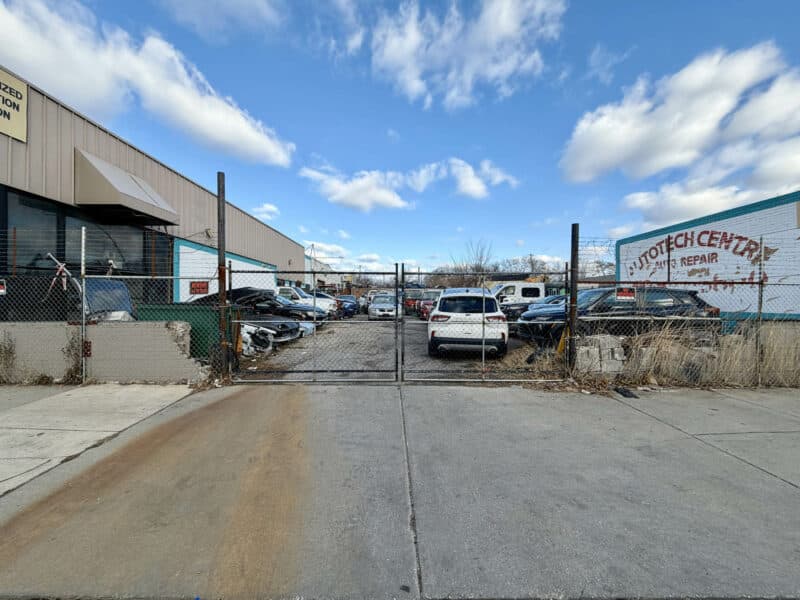 Gated commercial lot with vehicle storage at 3205 E. Madison Street and 3210 E. Monument Street in East Baltimore
