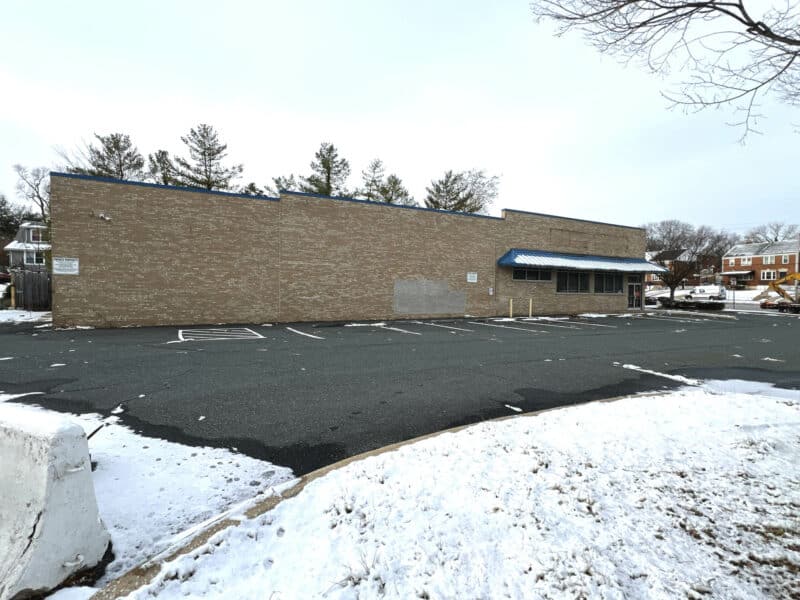Side exterior elevation of brick retail building at 3615 E. Northern Parkway.