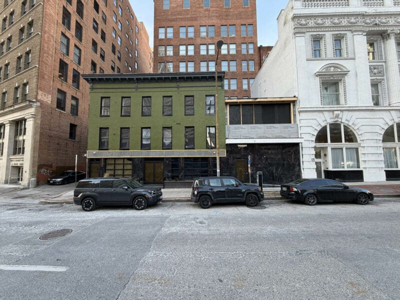 Full façade view of 8–14 Park Avenue commercial property with adjacent historic buildings.