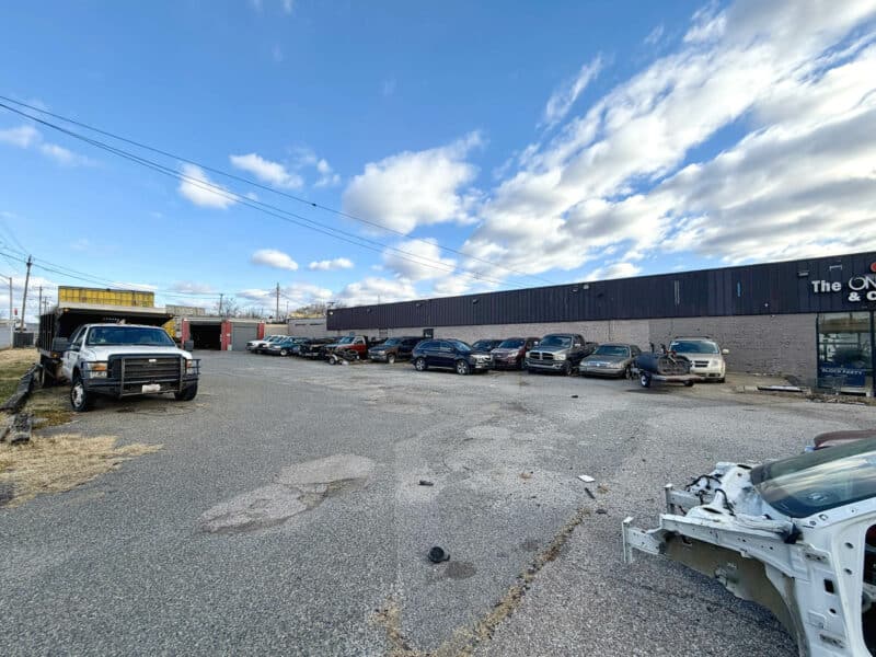 Paved parking lot with commercial building at 3205 E. Madison Street in East Baltimore City