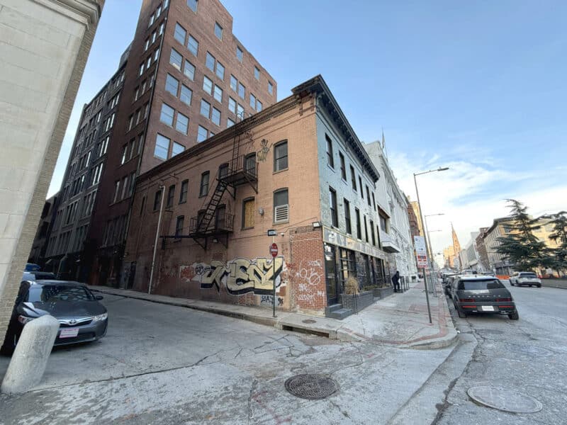 Side view of three-story brick building at 8–14 Park Avenue showing alley access.