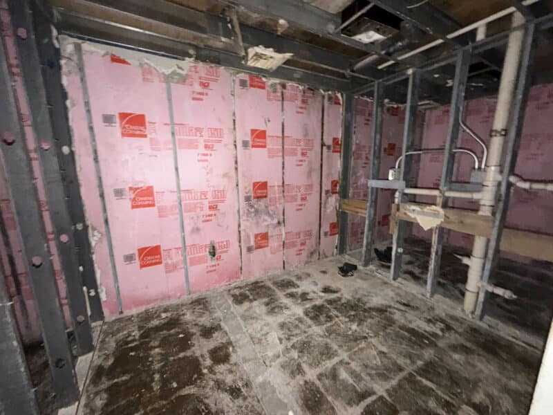 Interior utility area at 3615 E. Northern Parkway with exposed framing, plumbing, and mechanical systems.