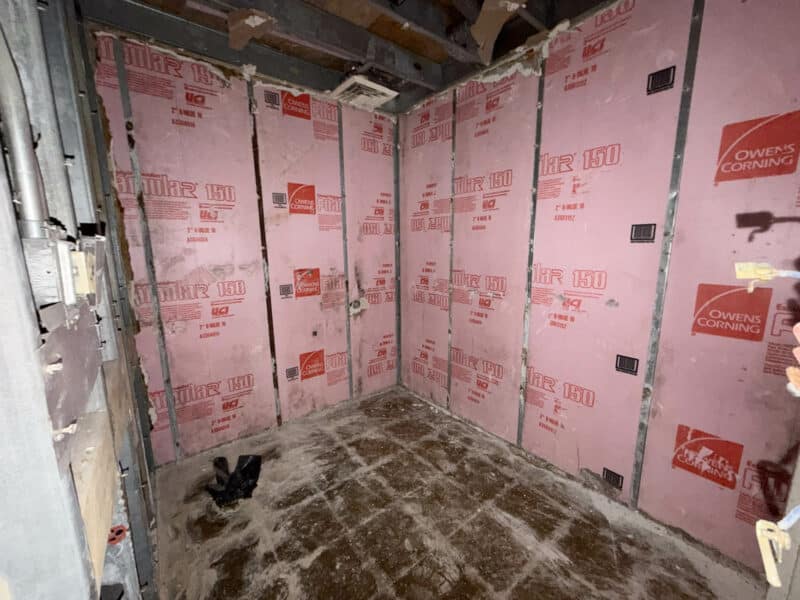 Interior service room of retail building at 3615 E. Northern Parkway with concrete floor and unfinished walls.