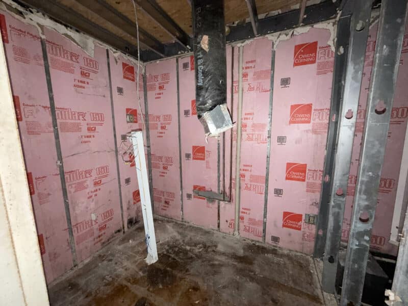 Mechanical area inside retail building at 3615 E. Northern Parkway showing exposed piping and unfinished interior.