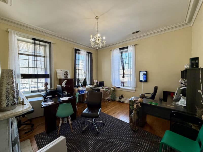Historic office suite with tall windows and chandelier lighting