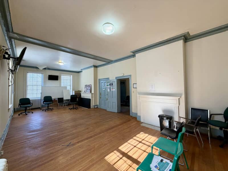 Large open interior room at McCabe Mansion with hardwood floors and high ceilings in North Baltimore