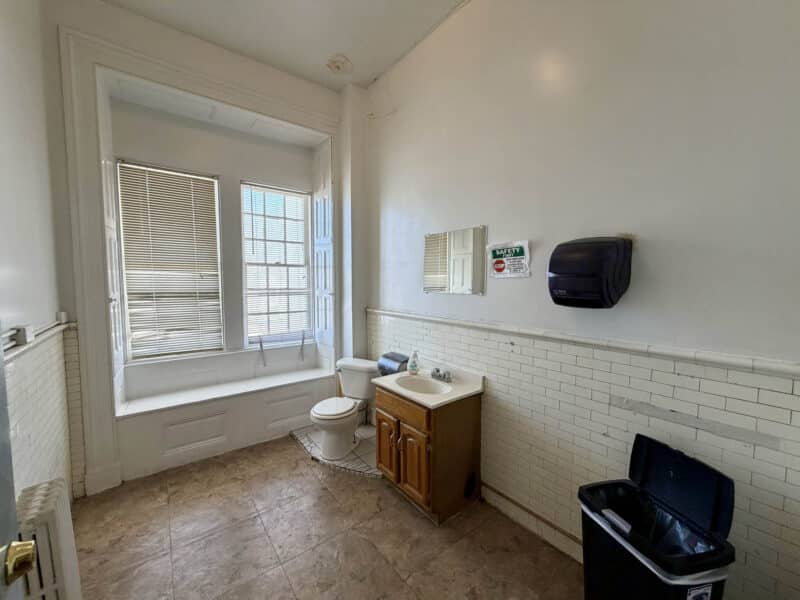 Commercial restroom with vanity and window at McCabe Mansion on York Road in Baltimore