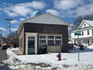 Corner brick building at 160 Main Street in Preston Maryland with storefront windows and front entrance
