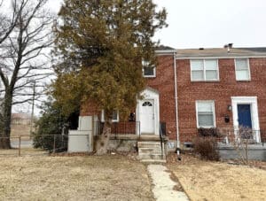 End-of-group brick two-unit townhouse at 1200 Woodbourne Avenue in Cameron Village, Baltimore Maryland