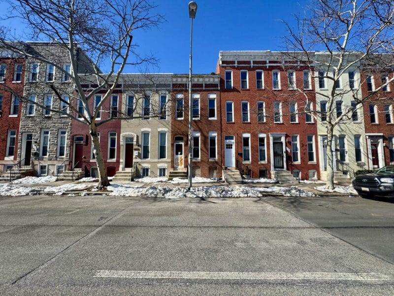 Row of brick townhomes along North Fulton Avenue in Sandtown-Winchester Baltimore