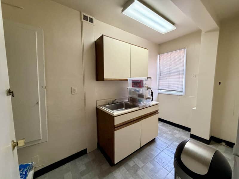 Commercial kitchenette at McCabe Mansion with sink and cabinets