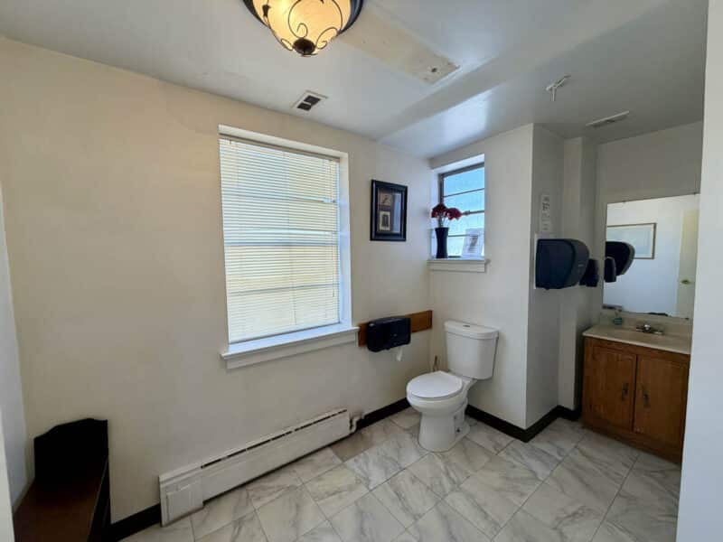 Commercial restroom with vanity and toilet inside McCabe Mansion office building