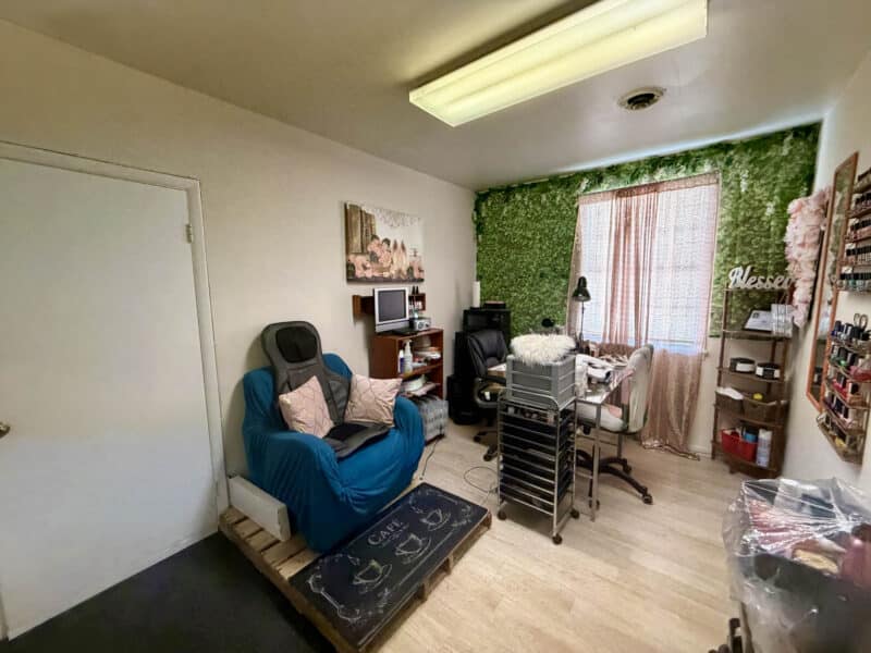 Tenant studio suite with workstation, shelving, and window inside McCabe Mansion Baltimore