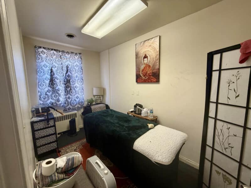 Private treatment room with massage table and window inside McCabe Mansion commercial office building in Baltimore MD