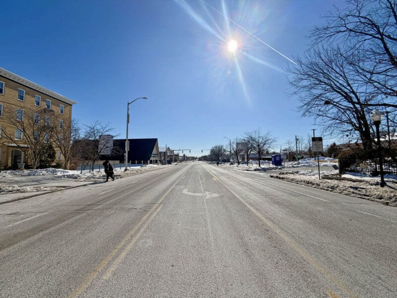 View along York Road near commercial building with sunlit roadway and surrounding neighborhood.