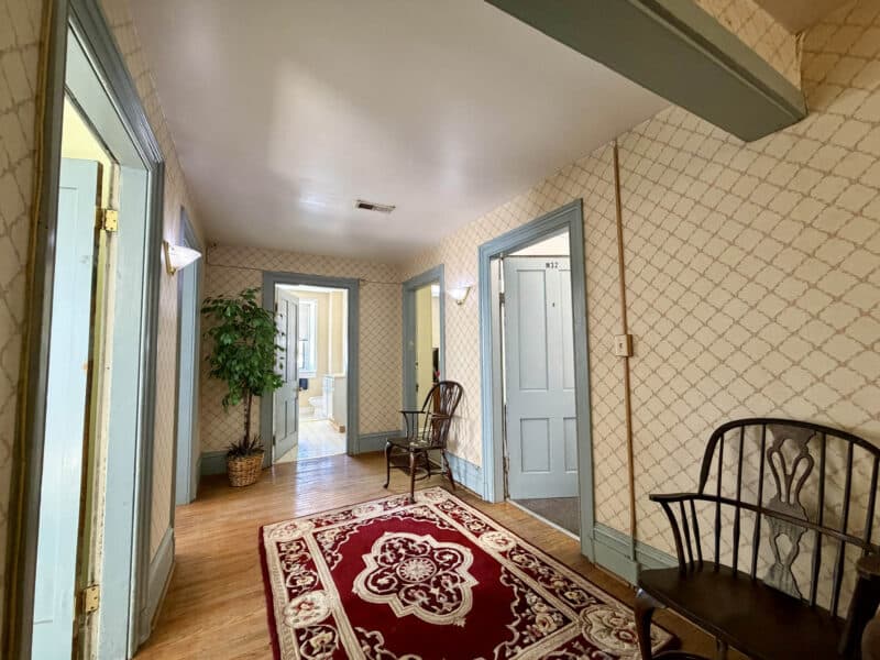 Interior hallway with hardwood flooring and multiple office entrances