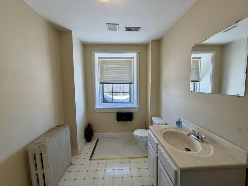 Commercial restroom with vanity and window at McCabe Mansion