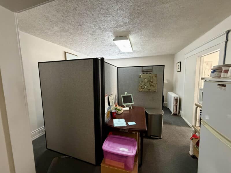 Office suite with partitioned cubicle and workstation