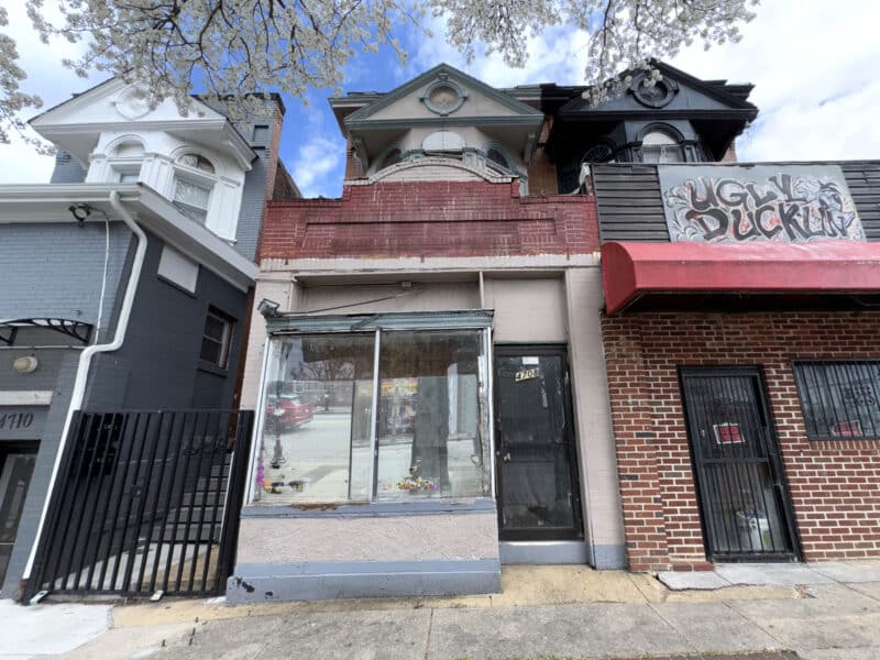 Mixed-use building exterior at 4708 Liberty Heights Avenue with storefront and upper-level apartment in Northwest Baltimore