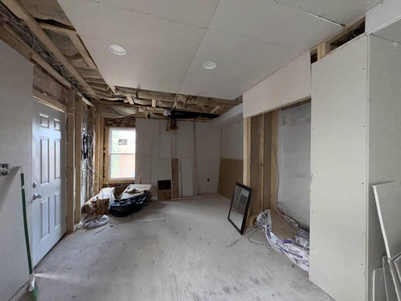 Open interior room with exposed ceiling and window in partially renovated building