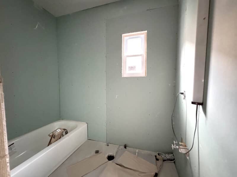 Bathroom under construction with bathtub installed and unfinished walls